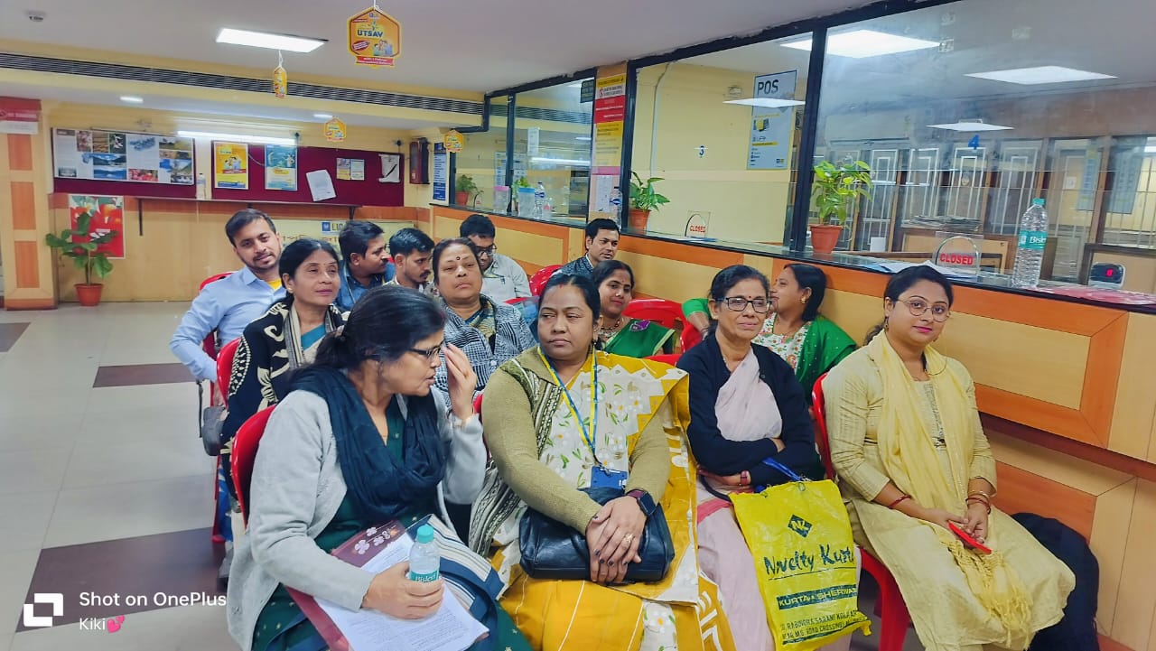back view of woman wearing a backpack and beanie waiting to cross the road on a busy street at night in New York City, USA
